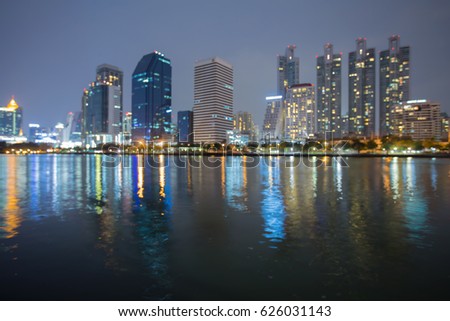 Night blurred bokeh light office building water front, abstract background