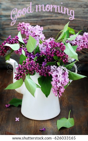 Postcard "Good morning!". Bright lilac. A bouquet of colorful lilacs. Lilac in a white retro jug (coffee pot). Place for text. Soft focus.