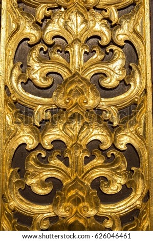 Thai flower pattern emboss woodcraft paint with gold color in temple, Asian style foral antique culture decorative art design handcrafted.