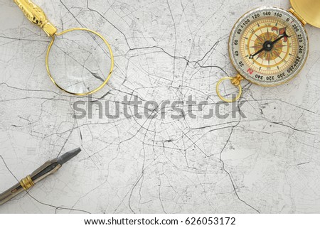 Image of map, magnifying glass and old compass. selective focus. travel destination concept