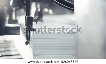 Printed sheets of paper are served in the printing press. Offset , CMYK Royalty-Free Stock Photo #626063549