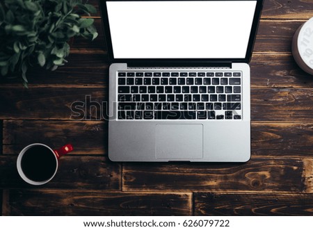Laptop on wood desk with bank screen for background concept,vintage tone