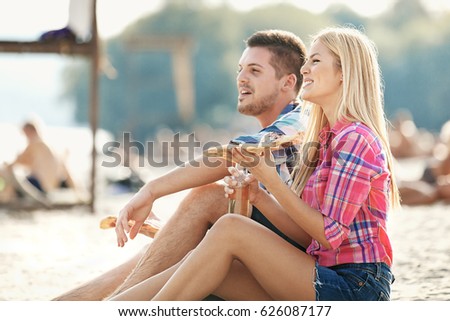 Happy couple having fun on the beach. Fun, summer, love concept. 