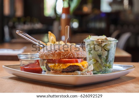 Hamburger with frech fries and caesars salad