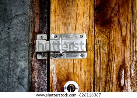 Locked door on wooden texture in a toilet