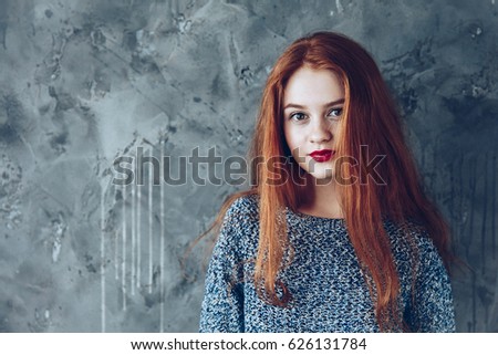 Portrait of cute beautiful young girl with freckles and red hair close-up. Sensitive red lips. 