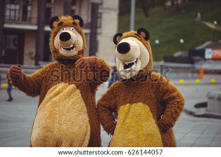 two men in a bear costume in the city, in day of protection of animals, festive entertainment Royalty-Free Stock Photo #626144057