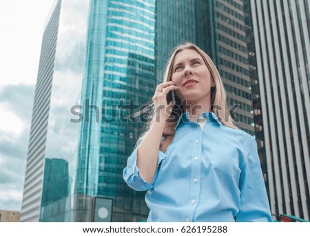Businesswoman. Happiness businessman with phone around skyscrapers in La Defence district in Paris City with sky background.