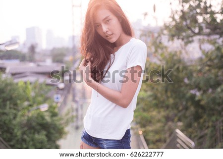 beautiful asian woman in white t-shirt on street