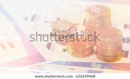 Stacks of gold coins on banking account in the background,color filter,graphs and charts