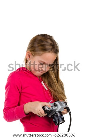 Little girl with an old camera isolated on a white background. Concepts : photography, retro, tourism, lifestyle. Studio portrait shot