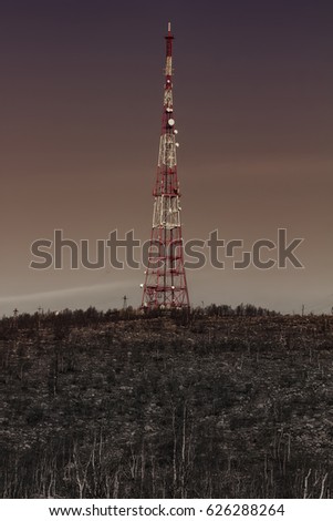 Price of technical progress. Concept. Modern telecommunications tower in dead forest