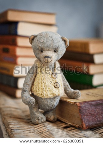 Teddy bear sits on a vintage book