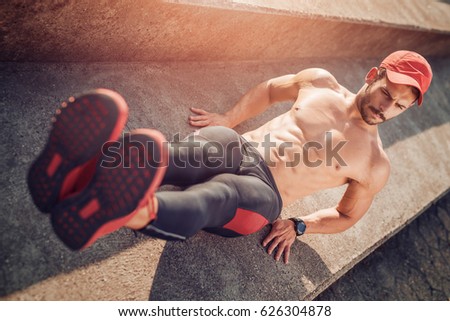 Young athletic man doing push-ups.Muscular and strong guy exercising.