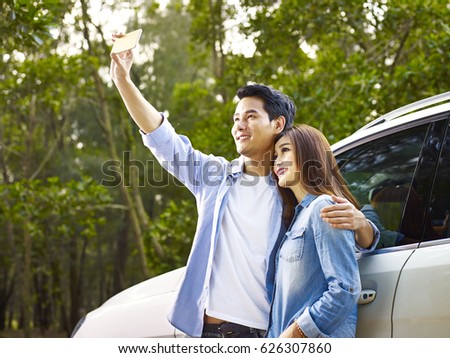 young asian couple taking a selfie during a trip.