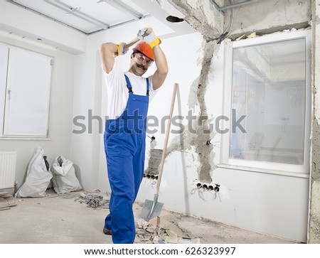Construction Worker Destroying Old House
