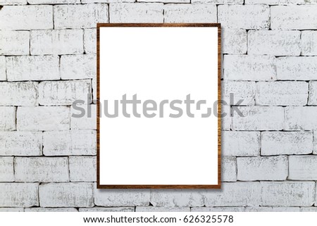 Mock up brown natural wood frame with blank poster hanging on brick wall in room