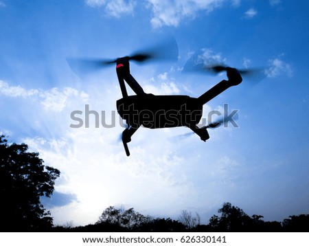 Drone flying on blue sky