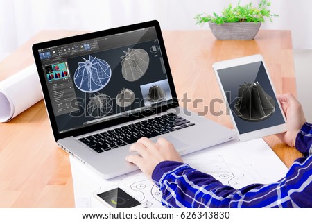 Cad engineer's workplace. Close up of engineer's hands working on the notebook and tablet. Royalty-Free Stock Photo #626343830