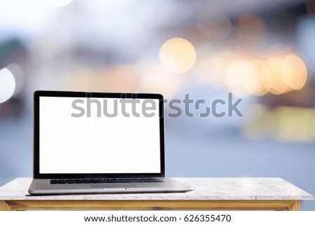 Laptop on wood desk with blurred background. For Graphic display montage.