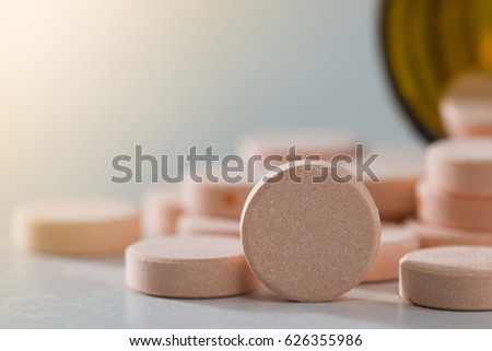 Orange pill or capsule on background with copy space Prescription for medicines Medicines in healthy containers antibiotics Royalty-Free Stock Photo #626355986