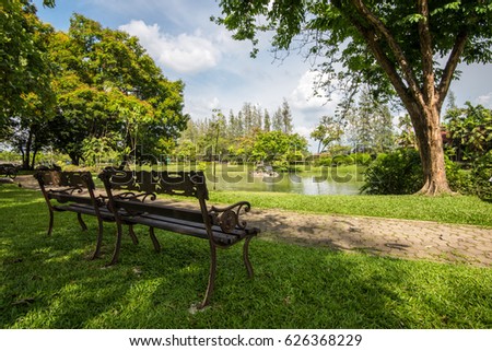 Bench in park with blue sky