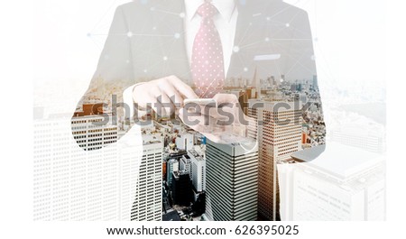 Business concept for information, communication, connection technology - double exposure effect of office man and panoramic modern city skyline bird eye aerial night view under dramatic dark blue sky