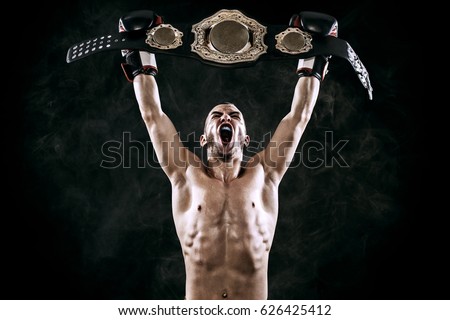 Boxer with Champion belt celebrating flawless victory isolated on black background with copy Space.. Royalty-Free Stock Photo #626425412