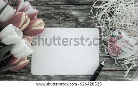 Tulips flowers bunch on dark barn wood planks background. Empty space for copy, text, lettering. Postcard, greeting card template.