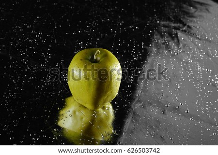 Apple in drops of water on an abstract background in drops