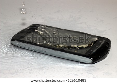Phone, smartphone flooded with water / Water, drops of water on the phone, smartphone