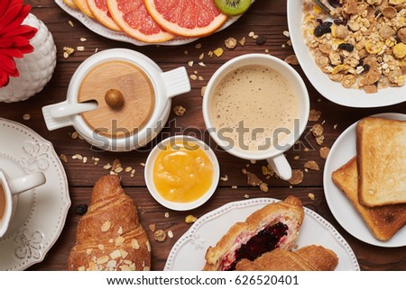 Flat lay picture of carbohydrate breakfast on wooden wretched background. Cup of coffee and honey. Yummy food