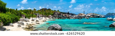 Panorama of a picture perfect beach with white sand, turquoise ocean water and blue sky at British Virgin Islands in Caribbean