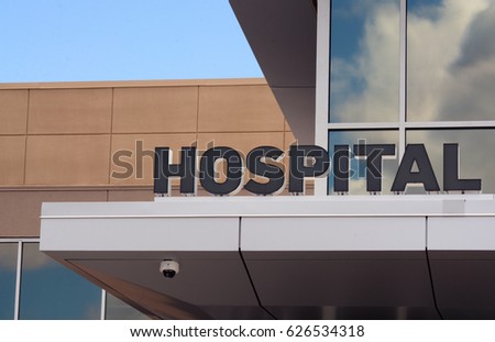 Hospital sign at entrance of small hospital building