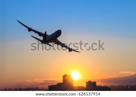 Airplane flying over city with skyscrapers at night. Turn right. Purple sunset. Boeing 747-8f. Royalty-Free Stock Photo #626537954