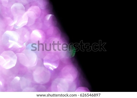 Abstract violet glitter lights isolated on black background. Round serenity defocused circles bokeh and shine glitters bright light. Template for design