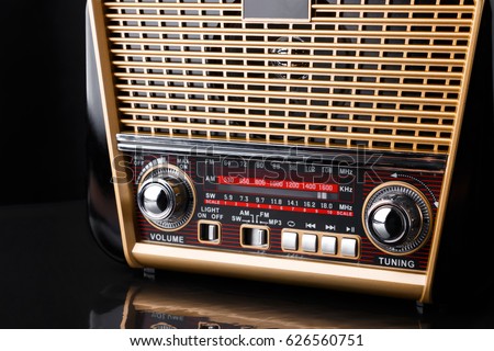 radio receiver in retro style with audio player on black background
