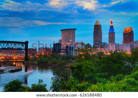 Downtown Cleveland beginning to light up at dusk with the Cuyahoga River winding past