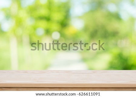 Empty table top on blurred nature background,Space for placing products