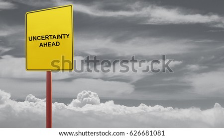 Uncertainty ahead concept- signage in a dark clouds