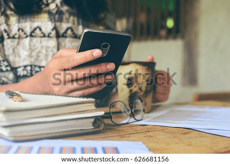 Business woman using mobile phone or smart phone to communicate business partner.