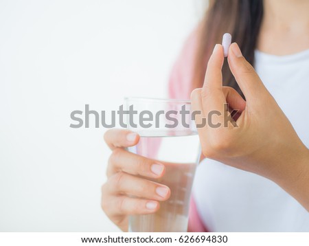 medicine, health care and people concept - close up of woman taking in pill Royalty-Free Stock Photo #626694830