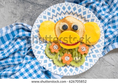 Funny monkey pancakes with fruits for kids breakfast