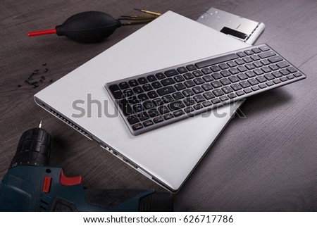 computer notebook with coponent and tool (repair concept) on wood table background