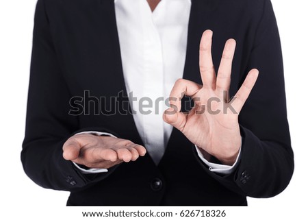 business woman open hand holding something and showing OK sign isolated on white background