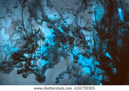 Luminescent. Underwater marvel. An experiment with water and ink. Fluorescent paint. Wonderful blue colors. Abstract background.