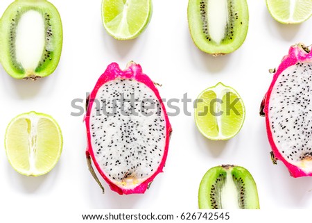 Tropical fruit design on white table background top view