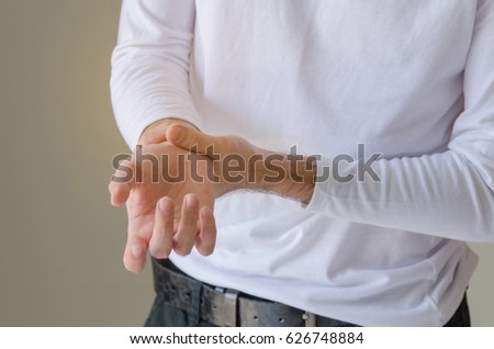 Man holding his hand - pain concept.