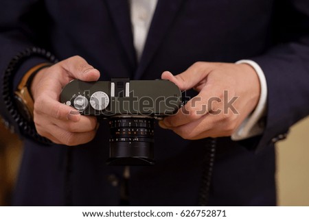 Man hand is holding a camera