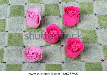 Pieces of soap on towel background